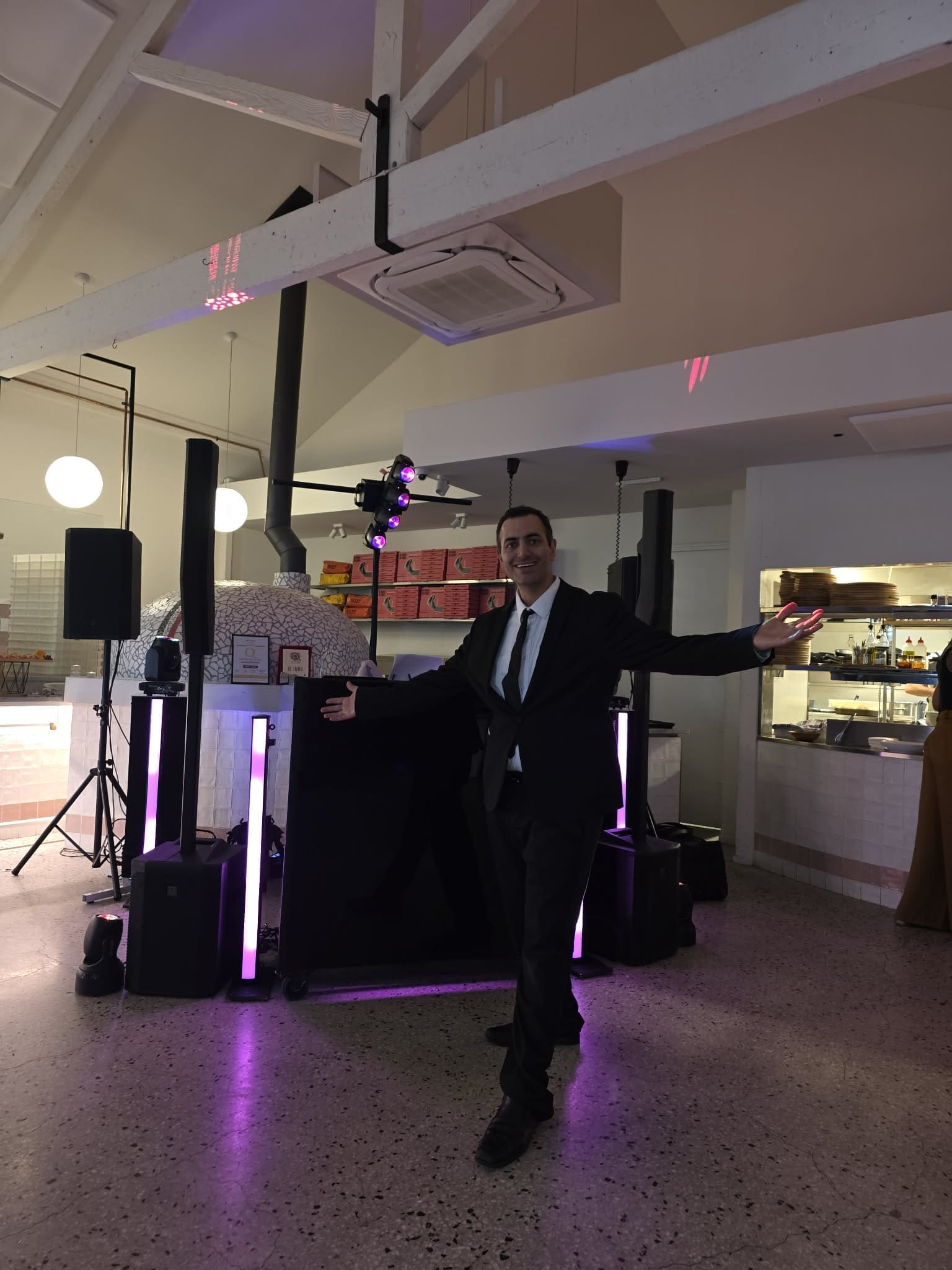 c8c3fa58-fdd2-4cdd-93de-8b5b3c3e8c2e Melbourne DJ hire setup with acrylic booth, column speakers and event lighting in modern venue